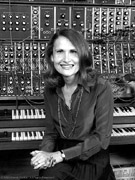 Wendy Carlos seated in front of her array of keyboards and electronic switches.